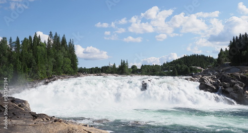 Scenic Laksforsen waterfall at Vefsna river in Grane town in Norway