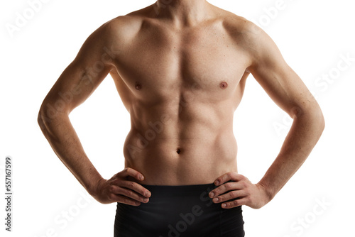 Cropped image of muscular male body, hands, belly. Man posing shirtless in black underwear over white studio background. Men's health and beauty