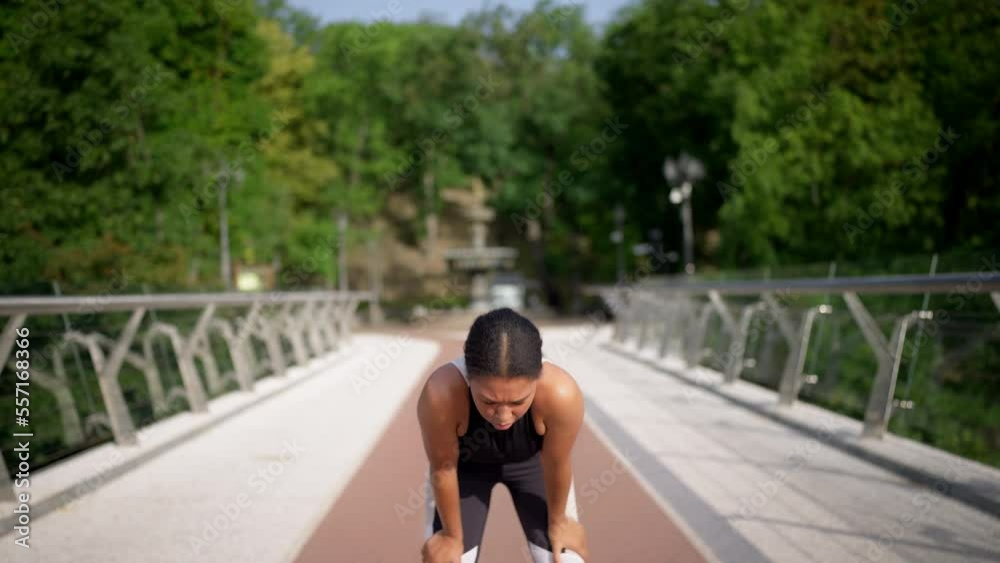 Tired woman making a stop while jogging in the city, morning workout, warming-up