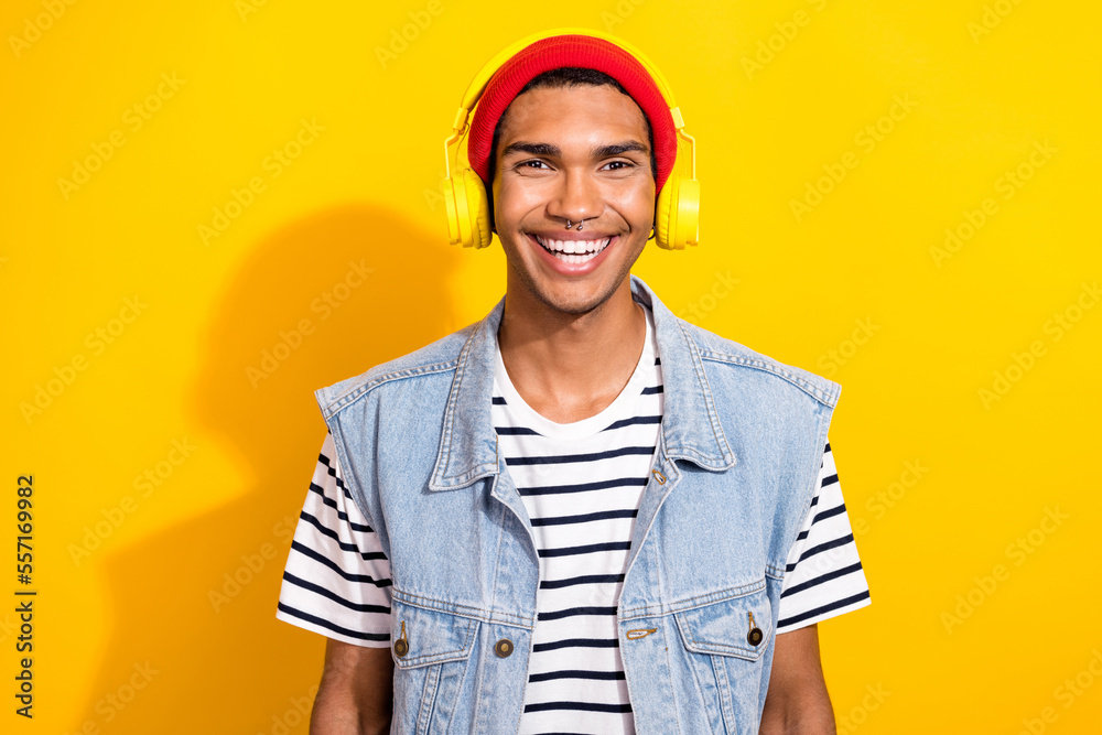 Photo of positive stylish man wear trendy clothes rejoice free time good mood isolated on yellow color background