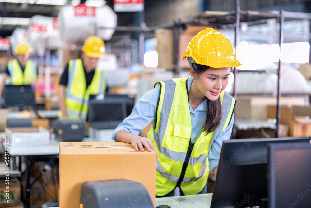 Worker working in the large depot storage warehouse happy smiling packing box at cashier counter Worker working in the large depot storage warehouse happy smiling packing box at cashier counter