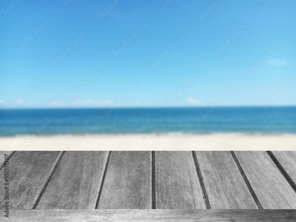   empty deck table top and blur tropical beach and blue sky nature of the background graphic illustration 