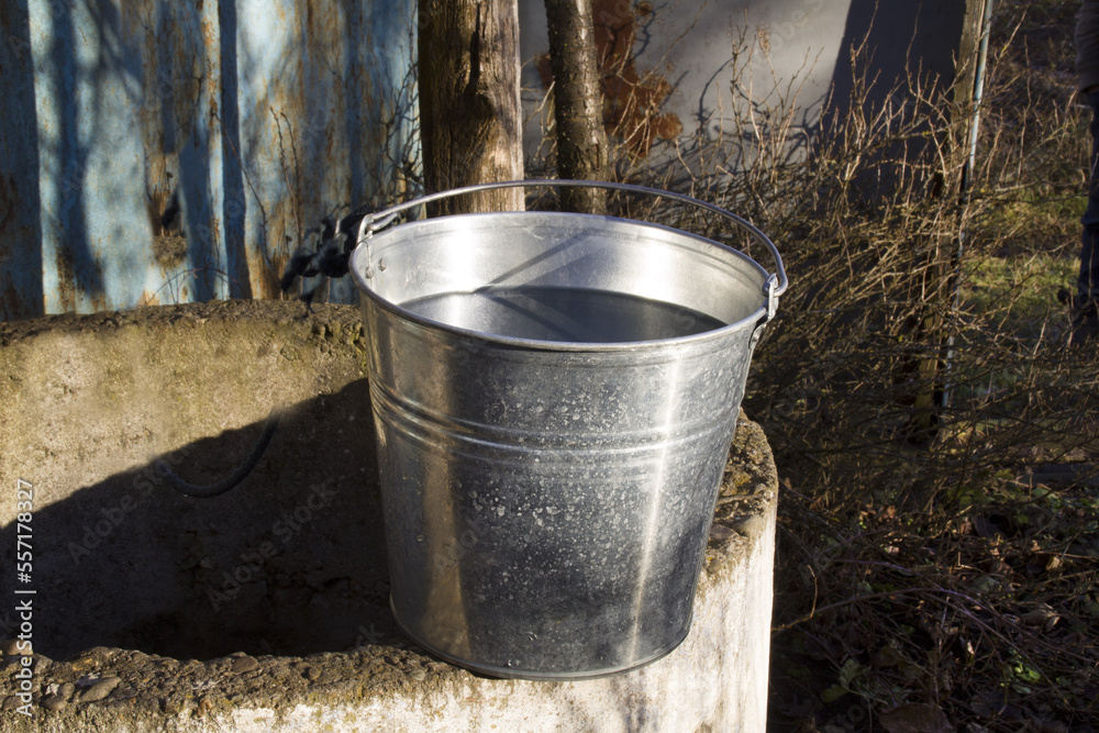 Rural well with a filled bucket of water