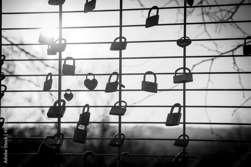 love locker locked to a fence in black and white