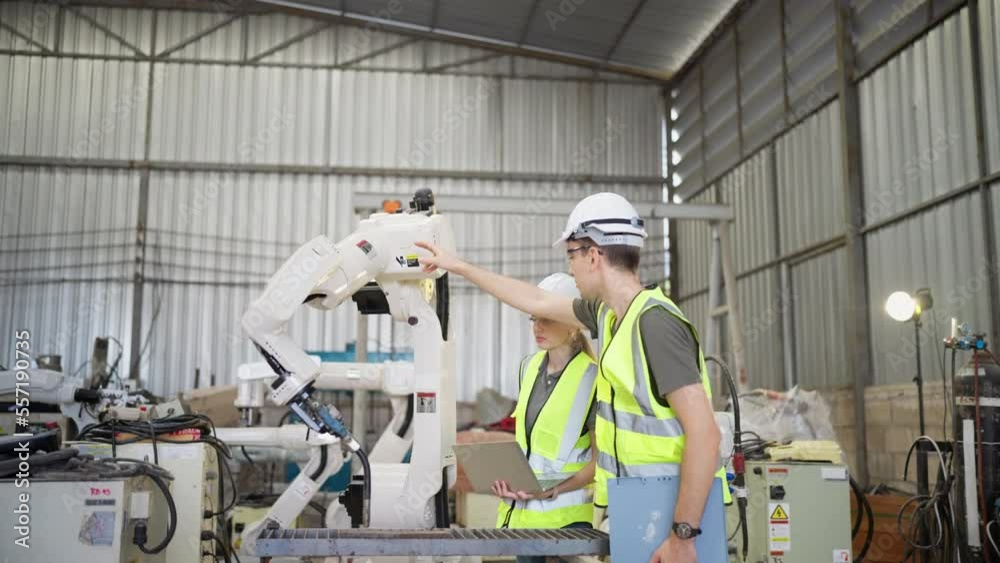 In robotic training instructor teach girl engineer to program robot arm look manual from laptop
In robotic training instructor teach girl engineer to program robot arm look manual from laptop