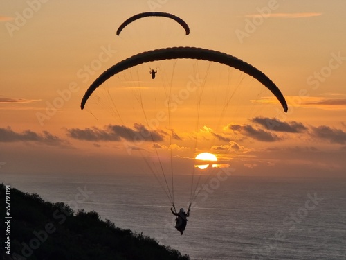 paraglider silhouette on sunset