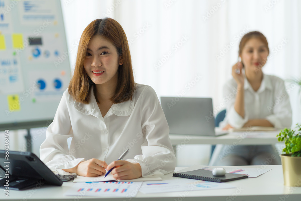 Friends of asia female employee worker discussing and accountant checking data document for investigation of corruption account. Anti Bribery concept, great business conversations Friends of asia female employee worker discussing and accountant checking data document for investigation of corruption account. Anti Bribery concept, great business conversations