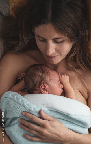 mother with her baby on her breast. concept of motherhood, newborn, care, protection, love