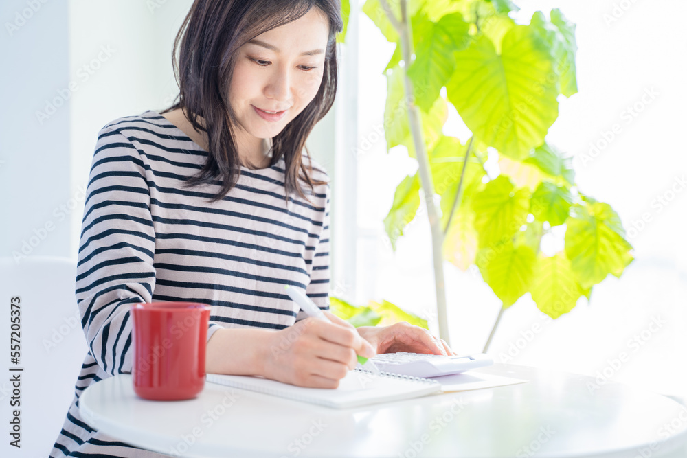家計簿をつける女性