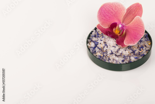 bath salt with pink flower on light white background