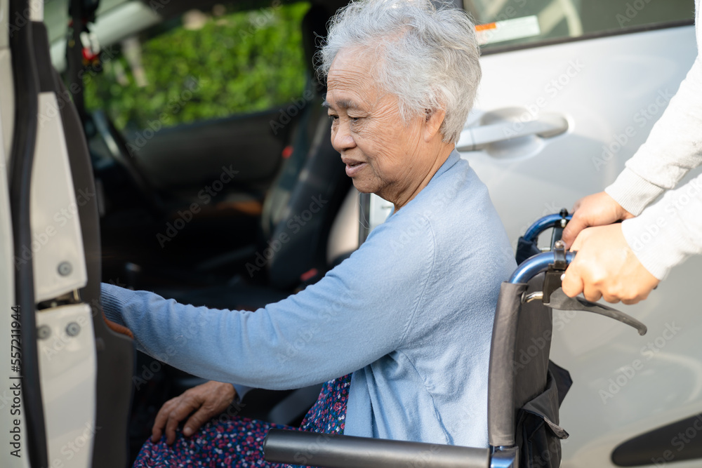 Obraz premium Asian senior or elderly old lady woman patient sitting on wheelchair prepare get to her car, healthy strong medical concept.