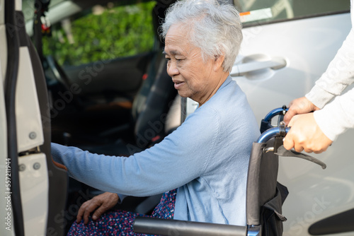 Asian senior or elderly old lady woman patient sitting on wheelchair prepare get to her car, healthy strong medical concept. © amazing studio