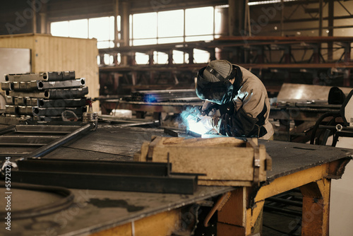 Man welding steel details using gas torch in his workshop  photo