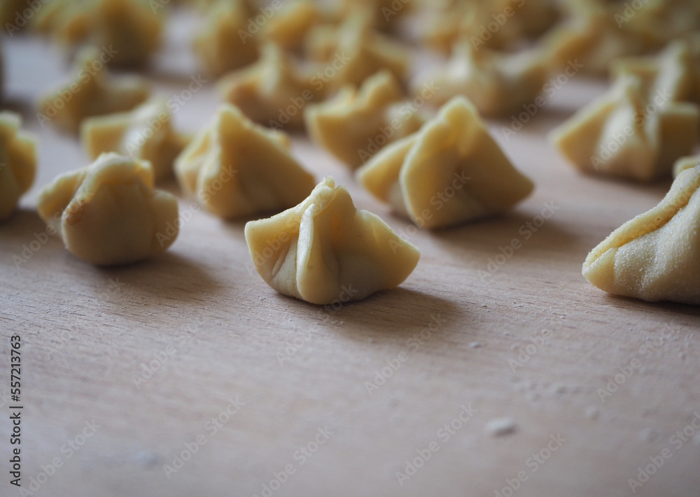 Close up of uncooked manti (Turkish ravioli), the famous dish of Turkish cuisine. Close up of uncooked manti (Turkish ravioli), the famous dish of Turkish cuisine.