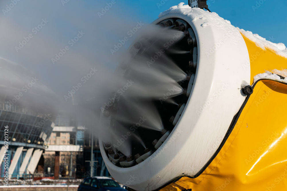 Snow cannon sprays artificial snow crystals. Production of artificial snow. The machine makes snow. Snow gun. Close-up