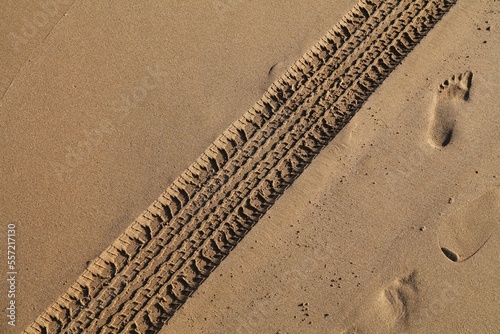 Car tyre tracks on beach sand
