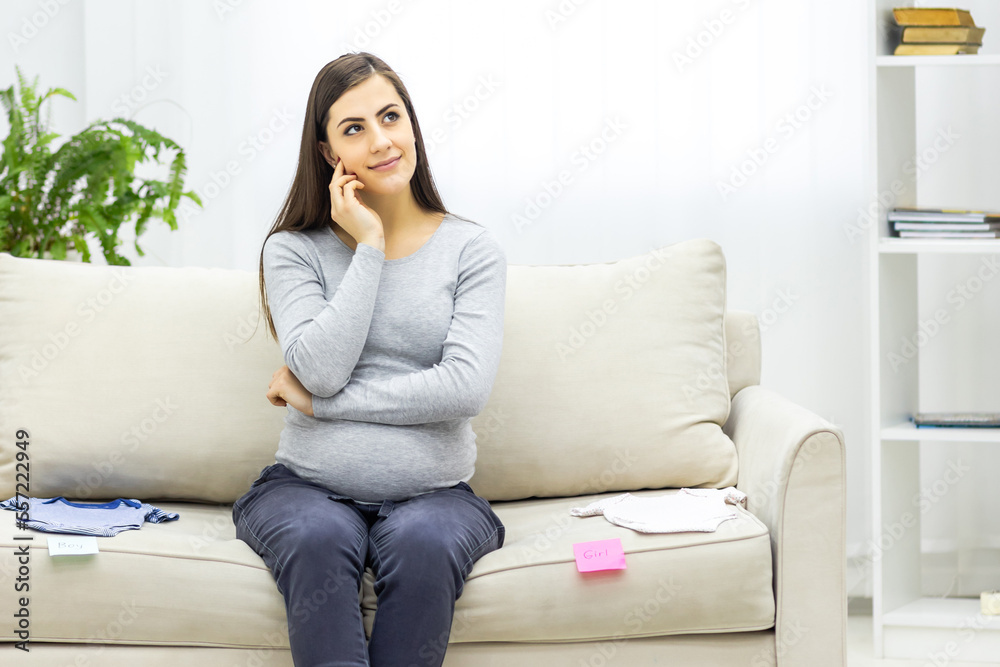 Photo of positive pregnant woman with pink and blue papers on the stomach which mean gender of future baby. Photo of positive pregnant woman with pink and blue papers on the stomach which mean gender of future baby.