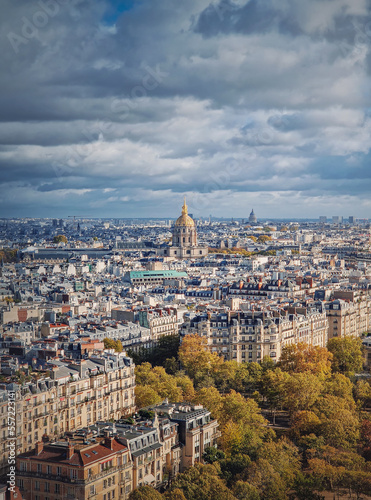 Scenery aerial view from the Eiffel tower height over the Paris city, France. Les Invalides building with golden dome seen on the horizon. Autumn parisian cityscape © psychoshadow
