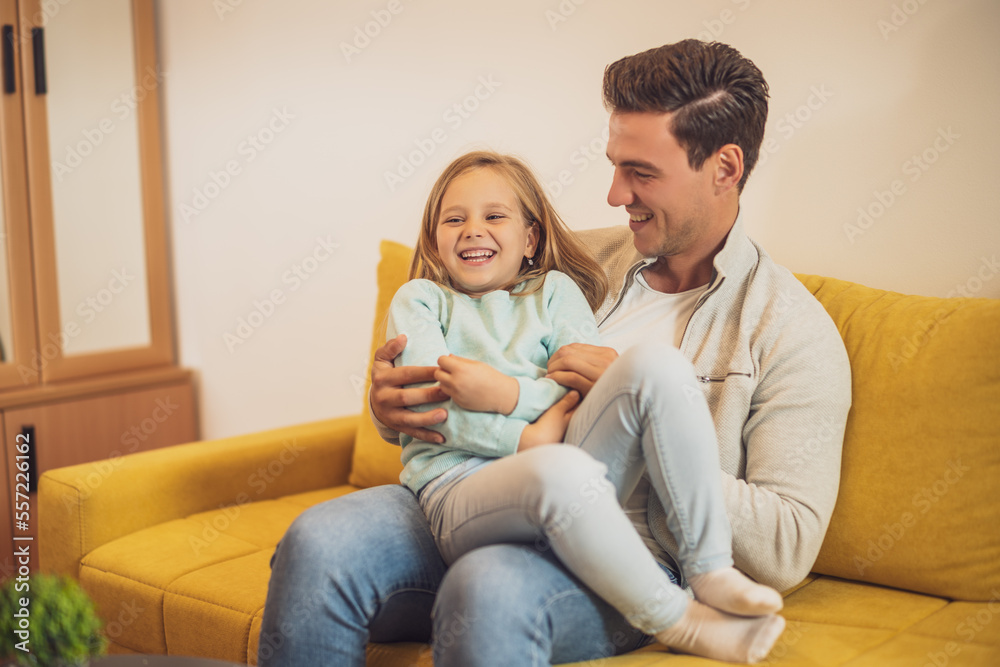 Happy father and daughter enjoy spending time together at their home. Happy father and daughter enjoy spending time together at their home.