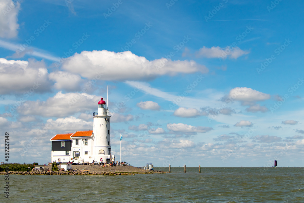 Marken lighthouse and fare off boats under Dutch blue sky