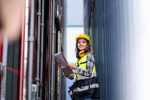 Canvas-taulu A female foreman works to supervise the loading of containers from a cargo ship for export and import