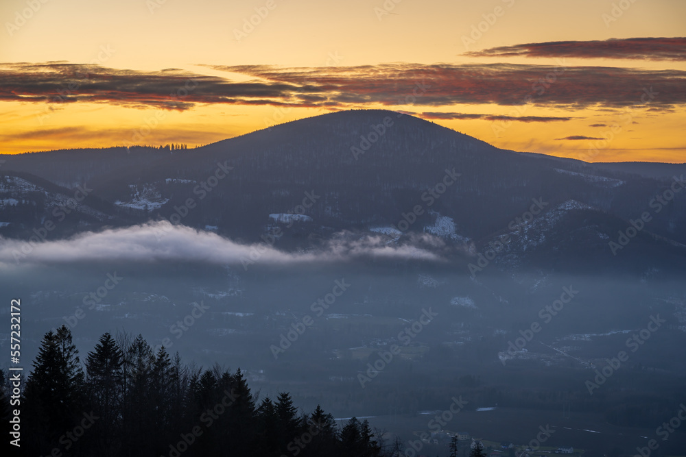 Winter sunset in Moravian-Silesian Beskids in Czech Republic, view of the Ostry peak with elevation of 1045 meters - obrazy, fototapety, plakaty 