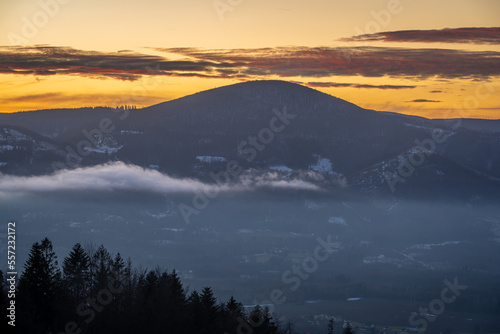 Winter sunset in Moravian-Silesian Beskids in Czech Republic, view of the Ostry peak with elevation of 1045 meters
