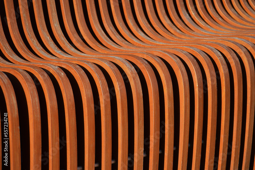 Curved wooden slats. Beautiful brown surface. Abstract background.