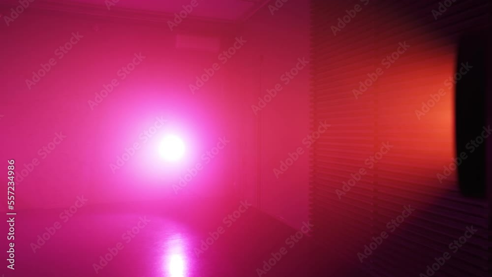 Lighting device shines with a beautiful orange and purple light. No people. Slow motion.