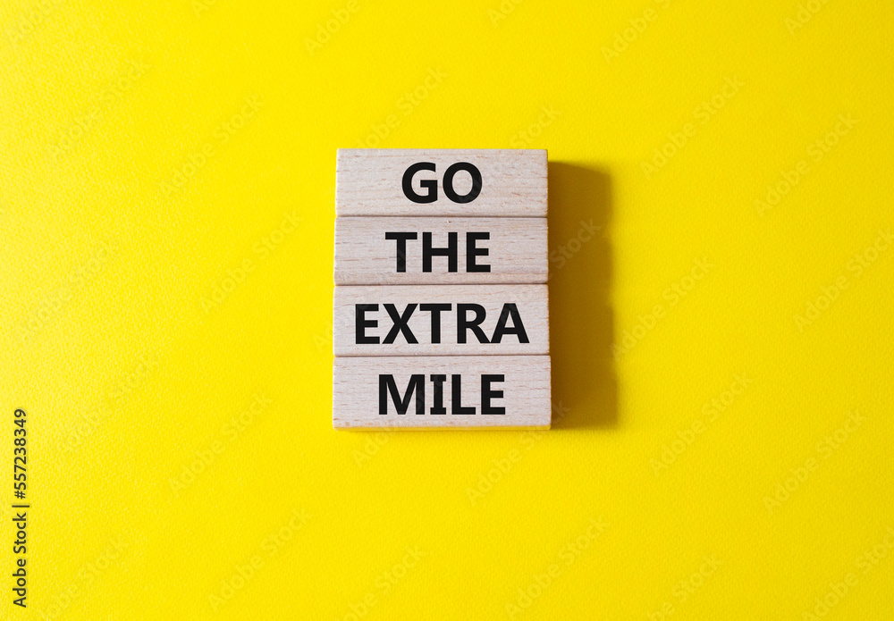 Go the extra mile symbol. Wooden blocks with words Go the extra mile