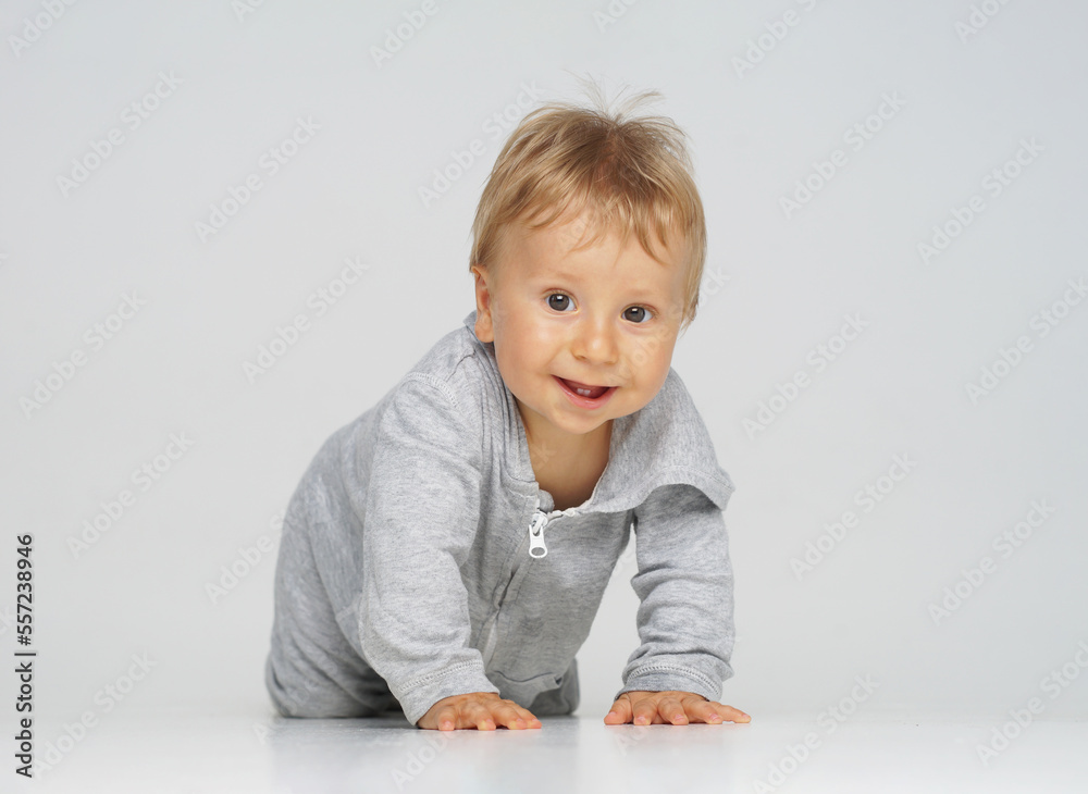 Little, happy and smiling cute baby in the studio. Portrait of a one year old baby. The concept of happiness. Little, happy and smiling cute baby in the studio. Portrait of a one year old baby. The concept of happiness.