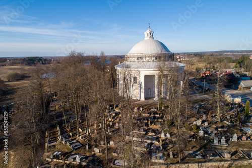 Holy Trinity Church in Suderve, Vilnius district, Lithuania. Cemetery in foreground. Drone. photo