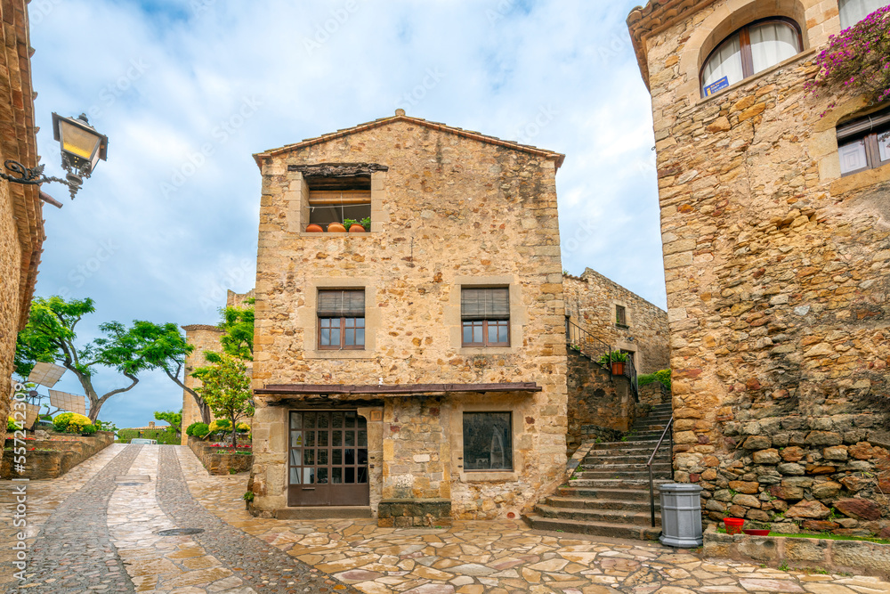 The wet streets of the medieval village of Pals, Spain after a summer rainstorm along the Costa Brava coast of the Catalonian region.	