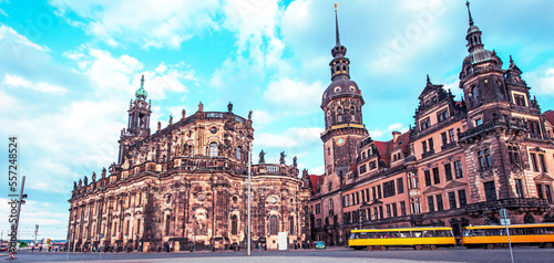 Beautiful landscape with yellow trams in the background Catholic Court Church (Katholische Hofkirche) in the center of old town in Dresden, Germany