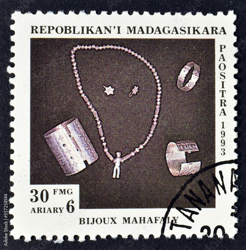 Cancelled postage stamp printed by Madagascar, that shows Jewelry Sakalava, circa 1993. photo