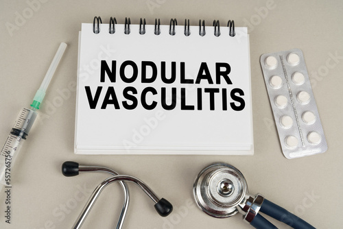 On a gray surface there is a syringe, a stethoscope and a notepad with the inscription - Nodular vasculitis photo
