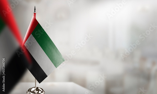 Obraz na płótnie Small flags of the Arab Emirates on an abstract blurry background