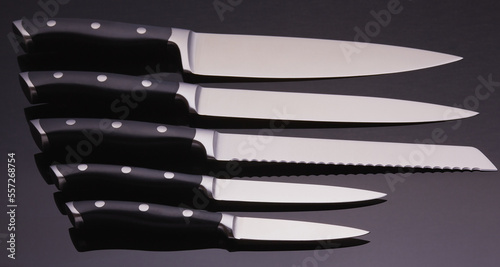 Set of luxury chefs knifes on a black background. photo