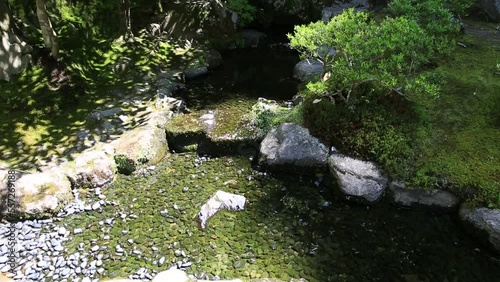 Zen water stream in the garden of popular Ginkaku-ji Temple or Silver Pavilion in spring season. Ginkakuji officially named Jisho-ji, is a Zen temple in Higashiyama District, Kyoto, Japan. photo