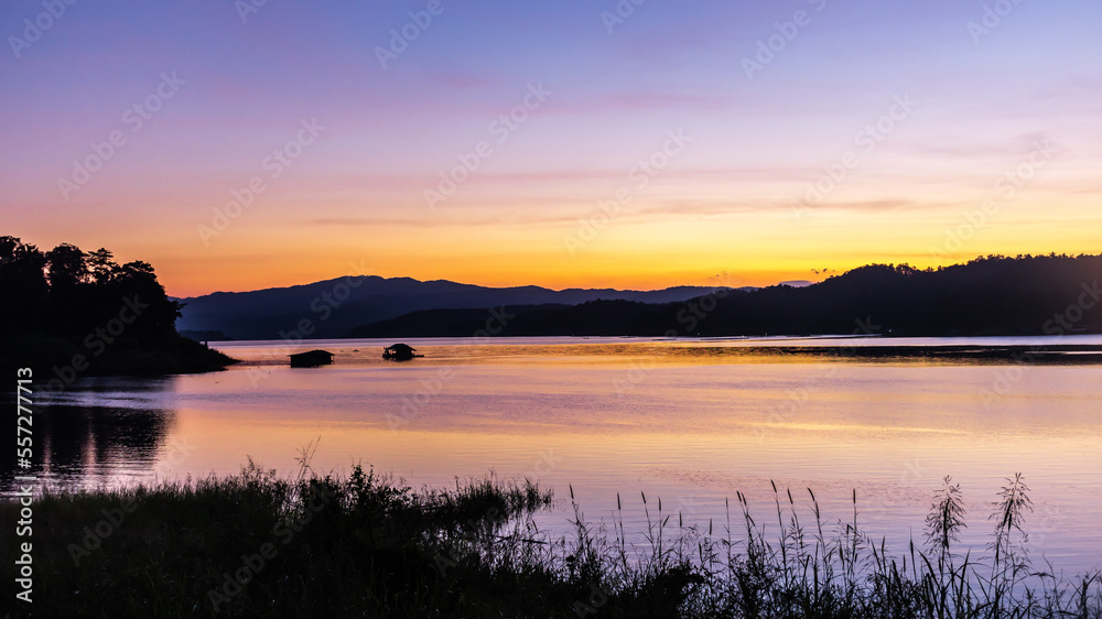 landscape sunset with Reservoir and raft house Thailand