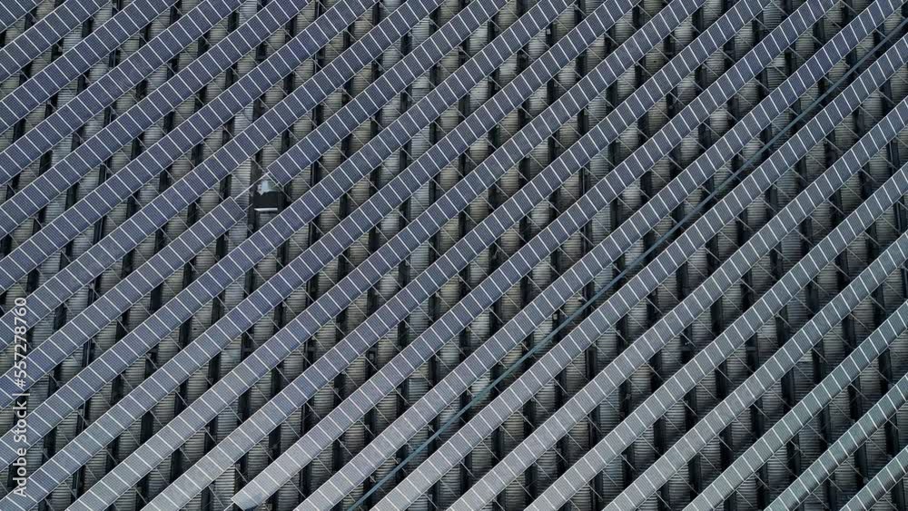 Close up - drone flying over never ending patch of solar panels Close up - drone flying over never ending patch of solar panels