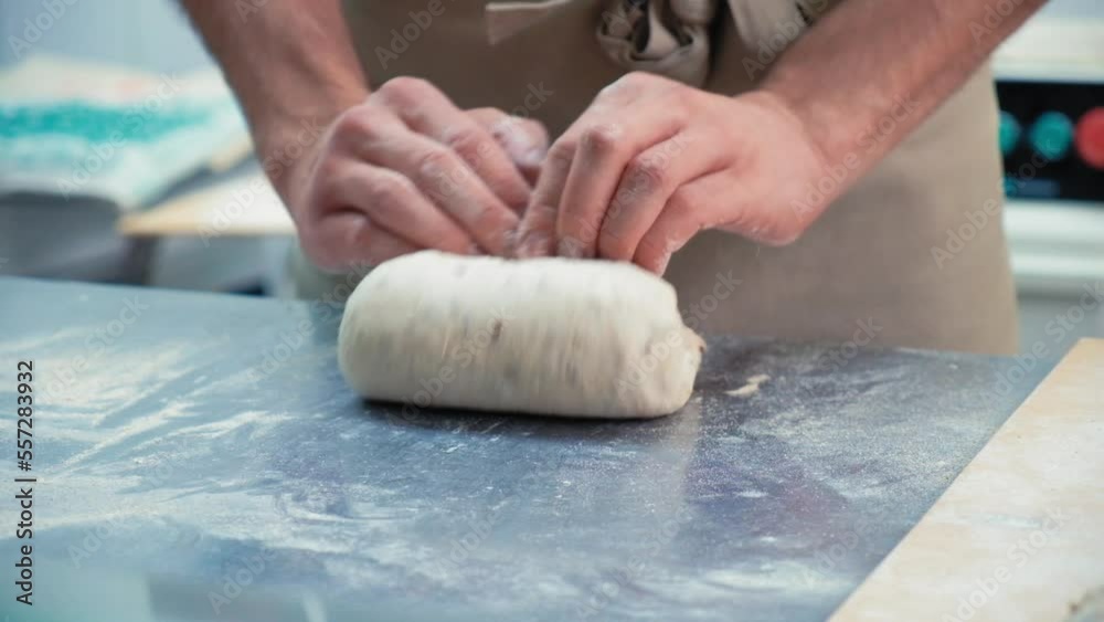 baker at work. The baker shapes the bread. Hands on the close-up foruyut bread baker at work. The baker shapes the bread. Hands on the close-up foruyut bread