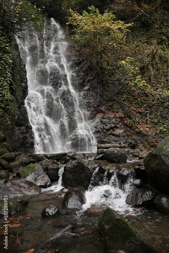 Picturesque view of beautiful mountain waterfall and rocks outdoors