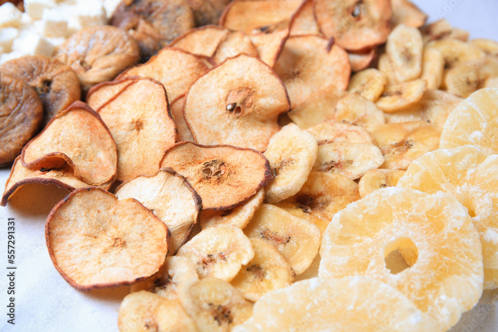 Different tasty dried fruits on paper, closeup Different tasty dried fruits on paper, closeup