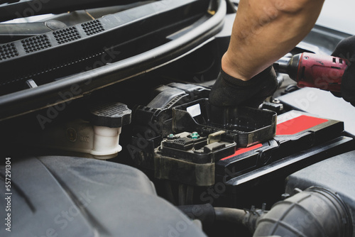 Picture of car parts and bumper repairman in front of car