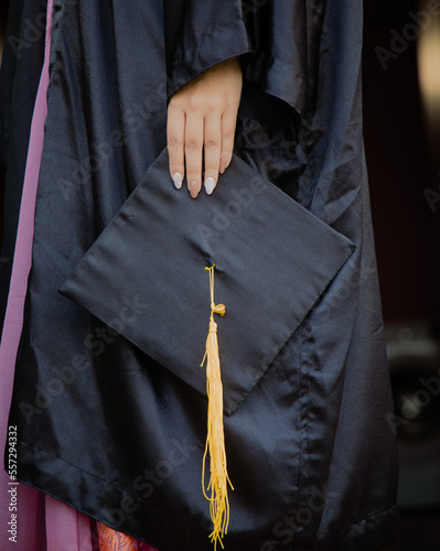 female graduate holding diploma