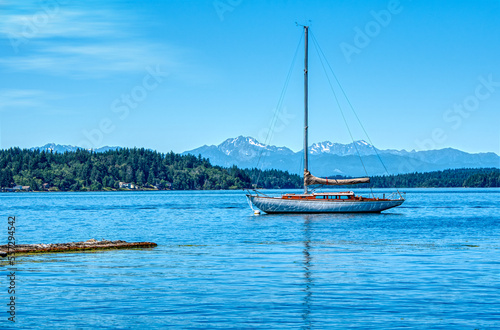 sailboat on the sea in a secluded harbor among mountains