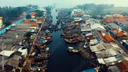 A view over a fishing village with boats floating on river in Kuala Sepetang Malaysia. photo