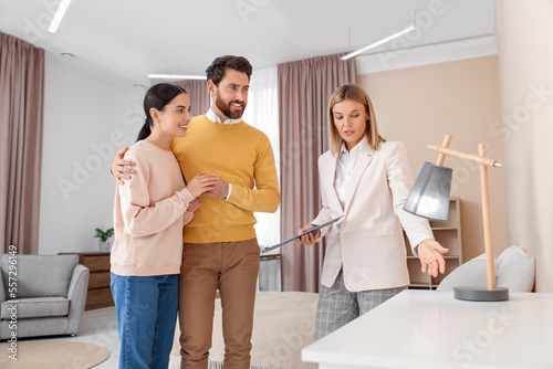 Real estate agent showing new apartment to couple