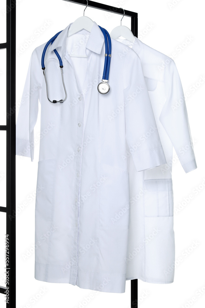 Doctor's gowns and stethoscope on rack against white background. Medical uniform Doctor's gowns and stethoscope on rack against white background. Medical uniform